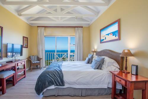 a bedroom with a bed with a view of the ocean at Luxury Lodge at Pinnacle Point in Mossel Bay