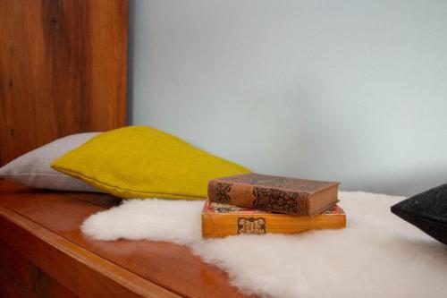 a couple of books sitting on top of a bed at Apartma Burk in Kobarid