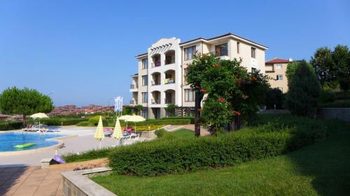 a large white building with a pool in front of it at Sozopol Paradise view in Sozopol