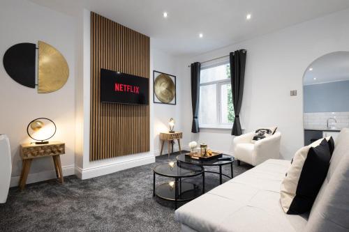 a living room with a couch and a table at Modern Boutique Studios in Central Bolton Perfect for Contractors & Short Stays in Bolton