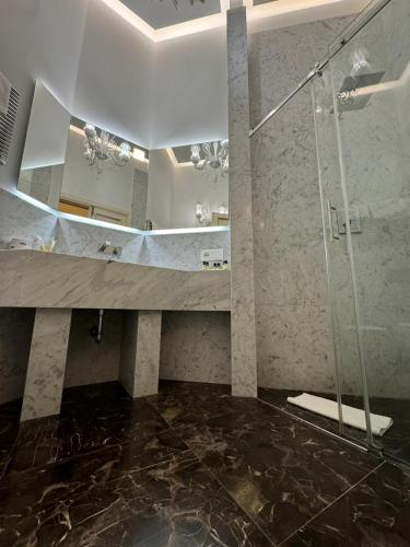 a bathroom with a glass shower and a sink at Delle Nazioni Milan Hotel in Milan