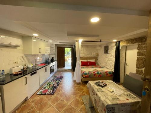 a kitchen with two beds in a room at Casa Pereira in Balança