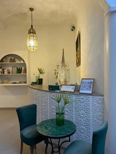 a cafe with a table and chairs and a counter at Riad Dar Blanche & Spa in Marrakech