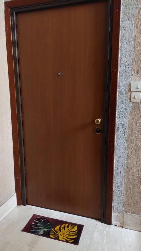 a brown door with a mat in front of it at Mary T House in Campagnano di Roma