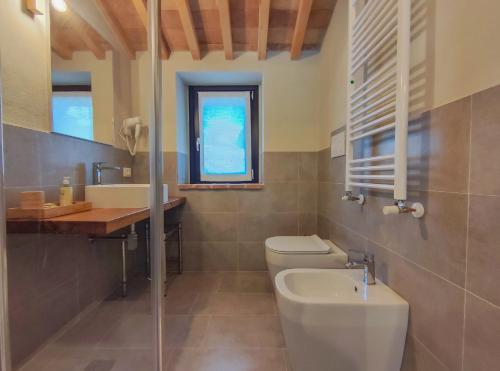 a bathroom with a toilet and a sink at La Fonte Delle Faranghe by Host Hero in Esanatoglia