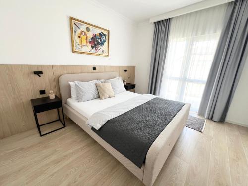 a bedroom with a large bed and a window at Apartments Mrdak in Bar