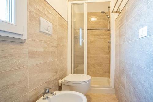 a bathroom with a toilet and a shower and a sink at La Terrazza sul mare in Porto Azzurro
