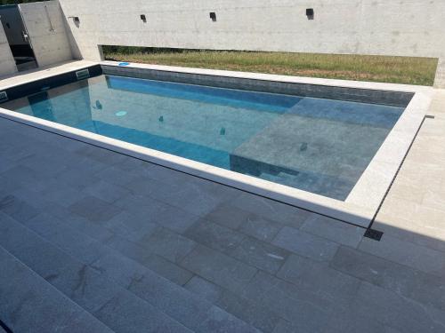 a swimming pool in front of a building at Vila Trnovac in Bužim