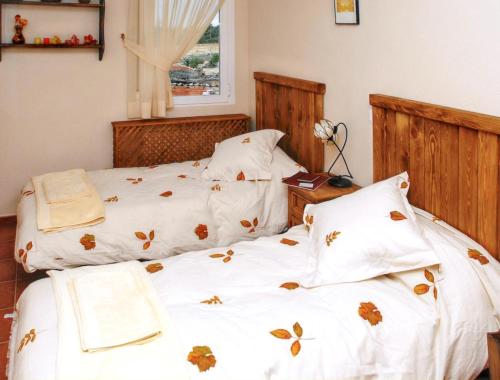 um quarto com 2 camas e lençóis brancos em 4 bedrooms house at Avila em Ávila