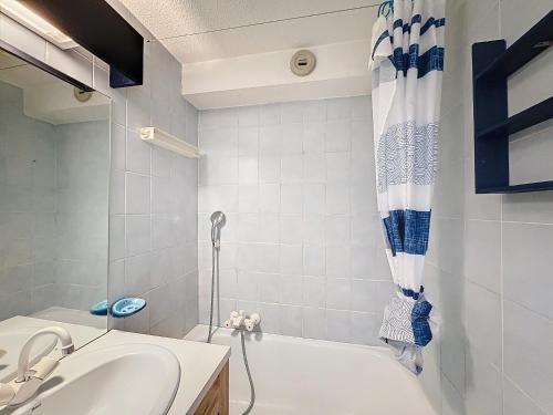 une salle de bain avec une baignoire et un lavabo dans l'établissement Soulane - appartement -4pers -centre, aux Gets