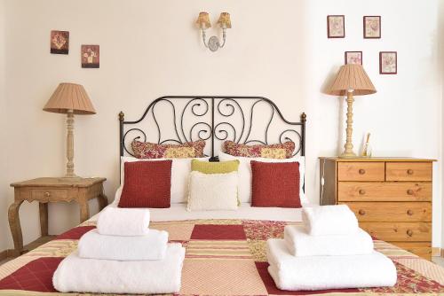 a bedroom with a large bed with pillows on it at Case del Vicolo Stretto in Modica
