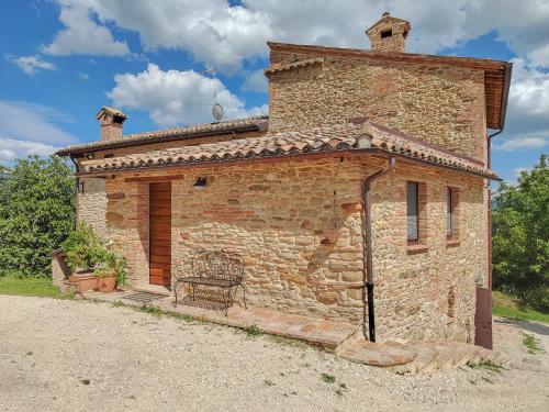a small brick building with a gate on the side at La Fonte Delle Faranghe by Host Hero in Esanatoglia