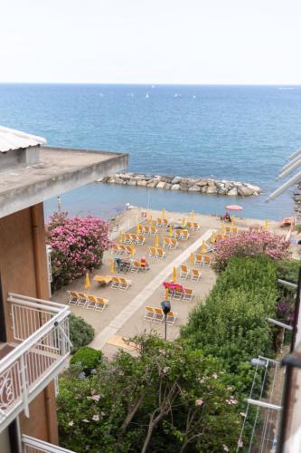 a view of the beach from a balcony of a resort at 25trilocale Vista Mare e spiaggia Amazzonia style in Diano Marina
