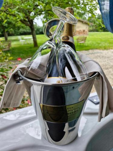 a bucket filled with bottles of wine on a table at Domaine Le Clos du Figuier Spa Grisolles in Verdun-sur-Garonne
