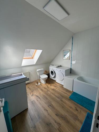 a bathroom with a sink and a toilet and a bath tub at Le coup de c’Heurt duplex 100m de la mer 8 personnes in Le Portel