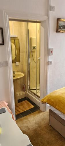a bathroom with a shower and a sink at The Chantry hotel in Dronfield