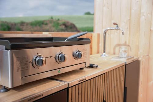a stove on top of a wooden counter at Fisherman's Cabin in České Budějovice