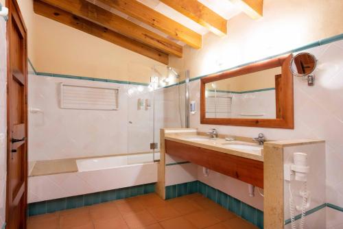 a bathroom with a sink and a tub and a mirror at Finca Son Roig by Valentin in Porreres