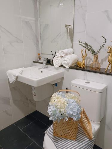 a bathroom with a sink and a toilet and a mirror at DiamondHouse in Hat Yai
