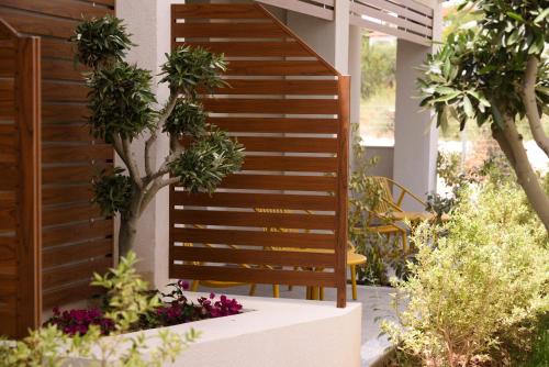 a wooden staircase in a garden with plants at Falena Luxury Rooms in Kalyves Poligirou