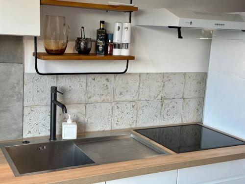 a kitchen with a sink and a counter top at Maisonette Sainte Victoire in Fuveau