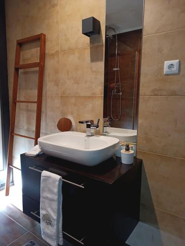 a bathroom with a sink and a mirror at Gerês VillaCella in Vieira do Minho