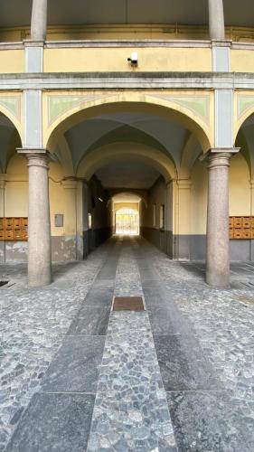 an empty hallway of a building with a large archway at Mantellini 2A in Domodossola