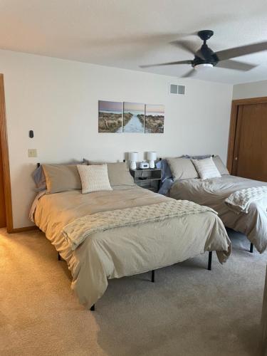 a bedroom with two beds and a ceiling fan at Beach Lake Michigan King Bed Pet Friendly in Kenosha