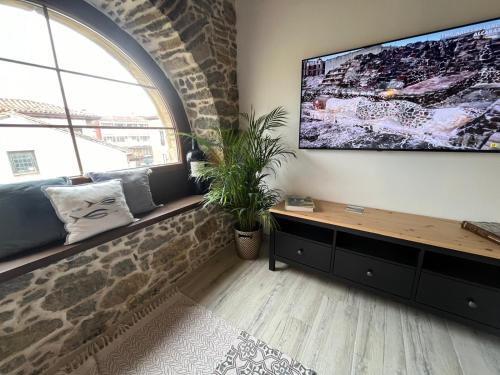 a living room with a large flat screen tv on a wall at Apartamentos BuenaVista in Colunga