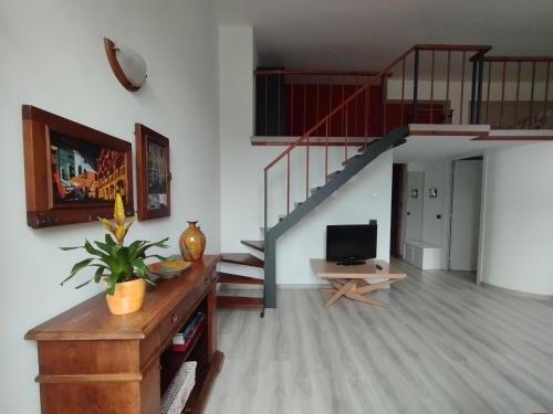 a living room with a staircase and a television at Mantellini 2A in Domodossola