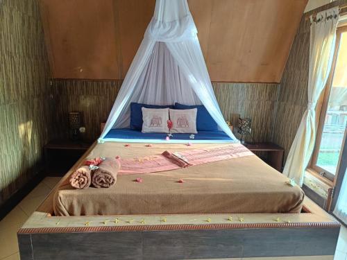 Cama o camas de una habitación en Noby Gili Cottages