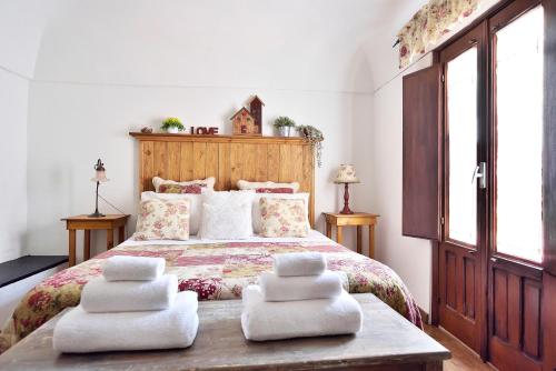 a bedroom with a bed with four pillows on it at Case del Vicolo Stretto in Modica