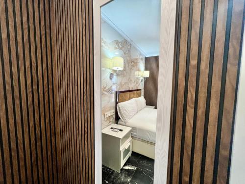 małą sypialnię z łóżkiem i lustrem w obiekcie Boutique Princesa w Marbelli