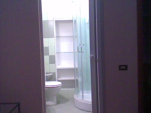 a bathroom with a toilet and a glass shower at Bed&Breakfast Giardino Agritourist in Controguerra