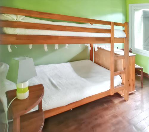 a bedroom with two bunk beds and a table with a lamp at Maison de 3 chambres avec jardin clos a Lacam d'Ourcet in Lacam-dʼOurcet