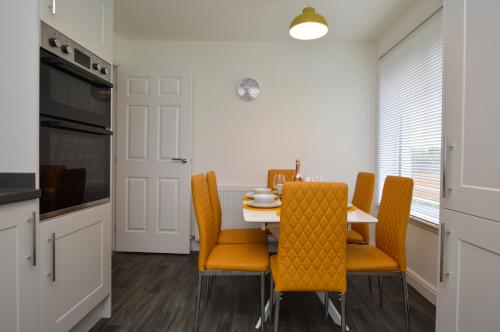 a kitchen and dining room with a table and chairs at Kilin in Lochgilphead