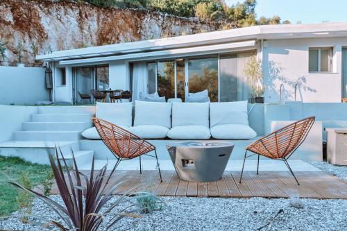 a living room with a couch and two chairs at Luxury Villas Theros with private pools in Sivota