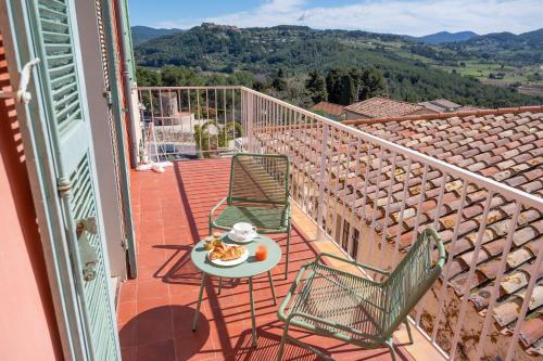 a balcony with a table with a plate of food on it at Maison Bérard Hôtel - Restaurant - Spa in La Cadière-dʼAzur