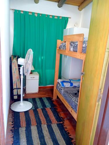 a bedroom with two bunk beds and a fan at Alojamientos Lilu in Colón