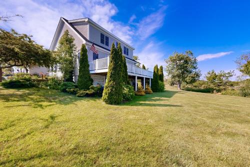 a large house with an american flag on it at Clark Cove in Harpswell Center