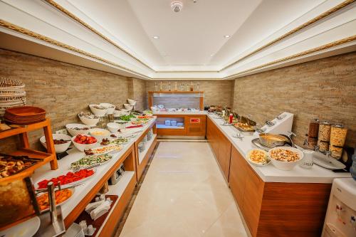 a large kitchen with many plates of food at OTEL MARCELLO in Istanbul