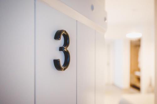 a number on a white cabinet door at Votsalo Tolo in Tolo