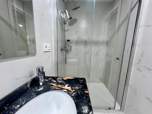 a bathroom with a shower and a white sink at SL Marbella in Marbella