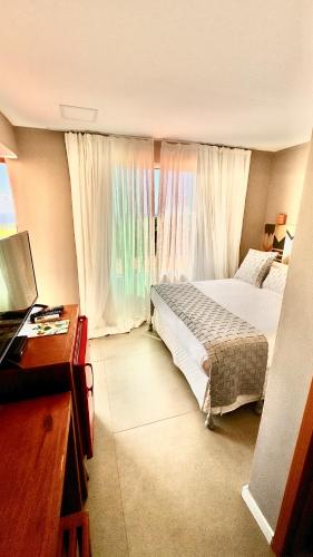 a bedroom with a bed and a large window at Pousada Alto Mar in Fernando de Noronha