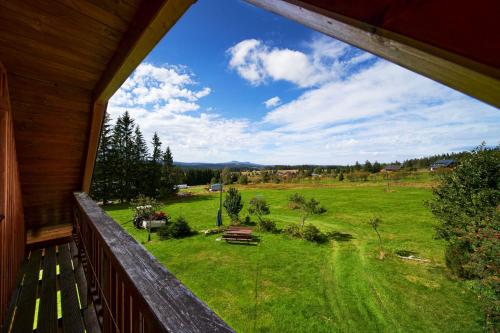 a view of a field from the porch of a house at Ubytování u Chladů in Horská Kvilda