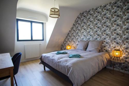 a bedroom with a bed with two lamps on it at -TY AR MOR- Belle maison corniche a 150m de la mer in Concarneau