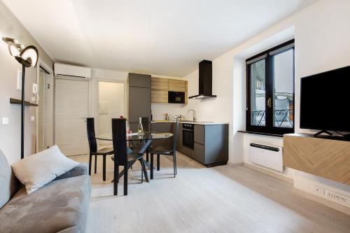 a kitchen and living room with a table and a television at Le Lavande in Castro