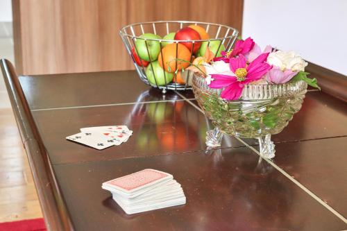 a table with a bowl of fruit and a vase of flowers at Lodges by Atholl Palace in Pitlochry