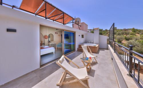 a balcony of a house with a bedroom and a bed at Pastel Rooms in Kas