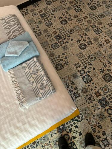 a bed with a towel and a rug on the floor at ILA Villa in Vajapūr